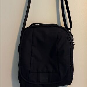 Durable Pacsafe Travel Crossbody with Locking strap and zippers.